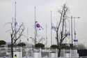 Mourners watch the site of a plane fire from outside of Muan International Airport in Muan, South K…
